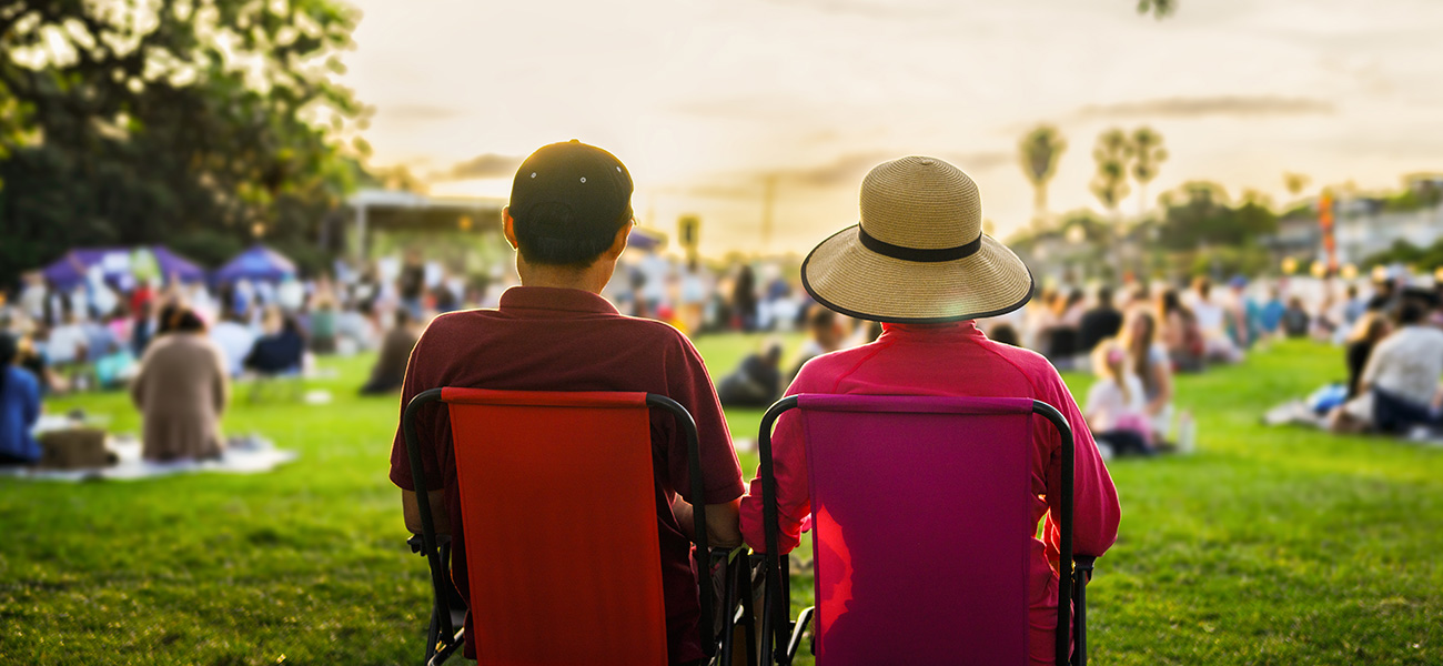Couple at an outdoor summer concert in the park.