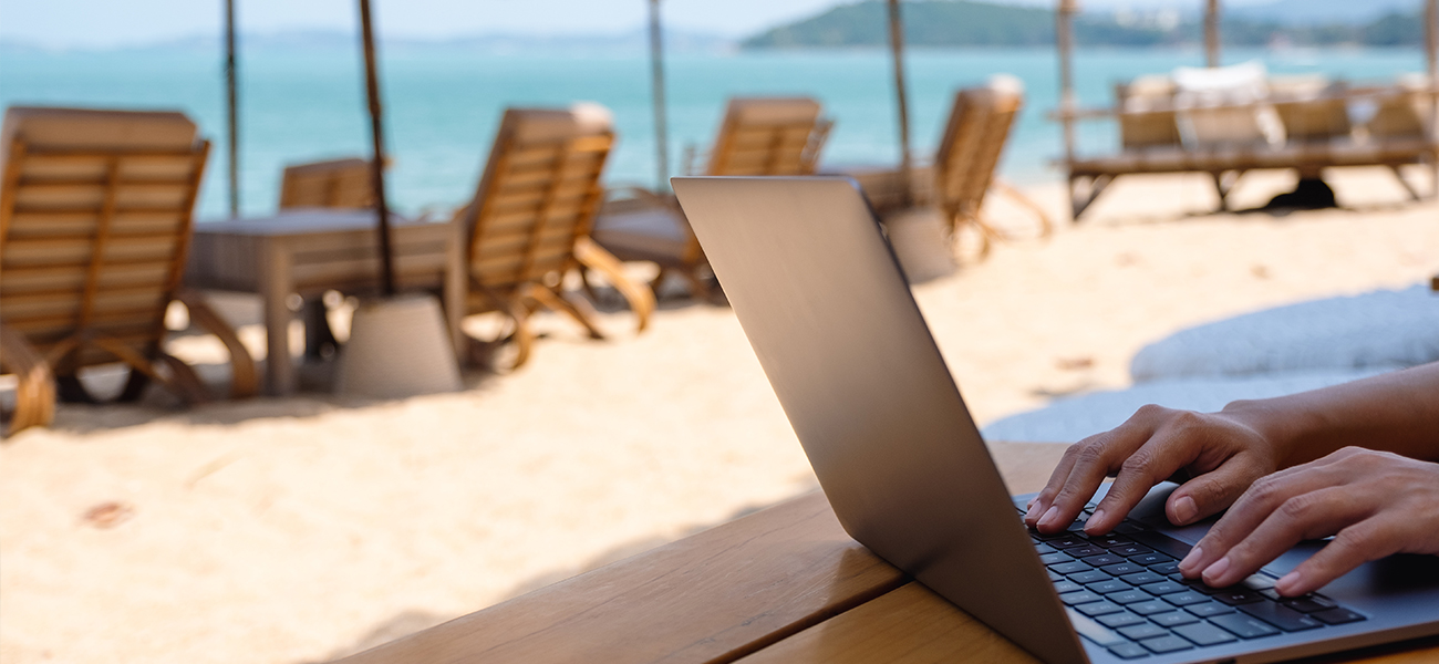Person working remote from the beach.