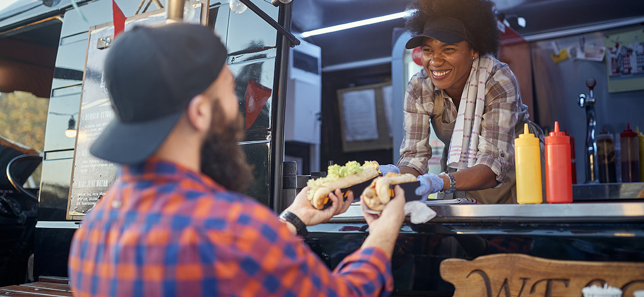 Man getting food at a food truck.